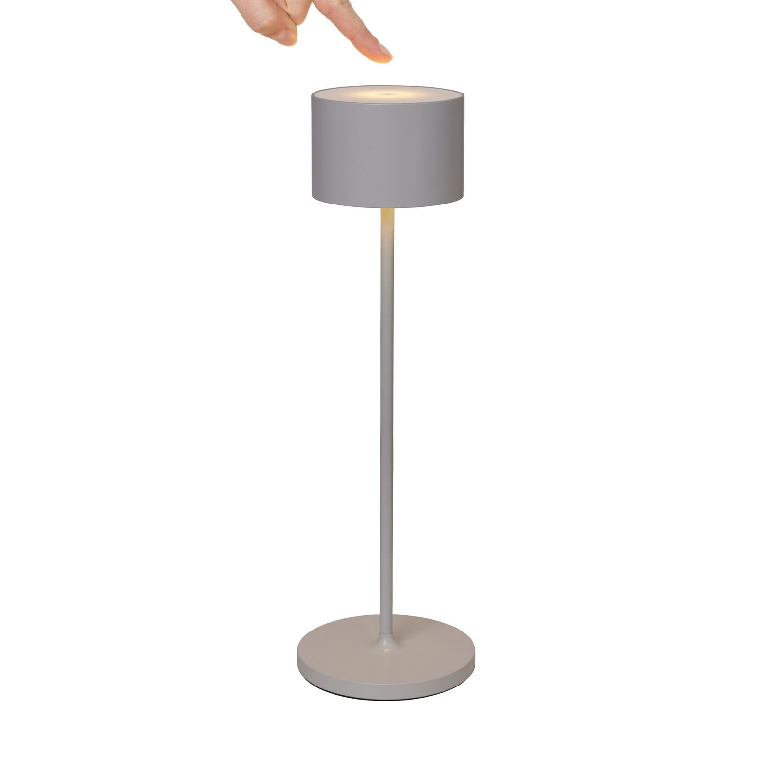 Modern grey floor lamp with a cylindrical shade and a hand pointing at it.