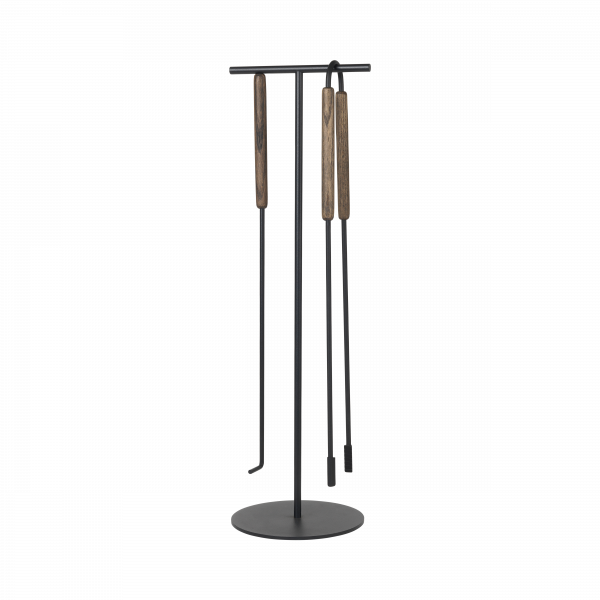 Stylish black metal tool stand with wooden handles for fireplace tools.