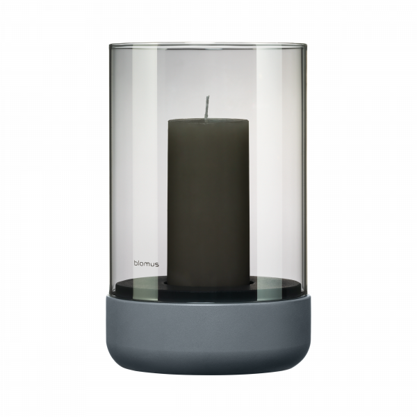 Elegant glass candle holder with a dark candle, designed by Blomus.