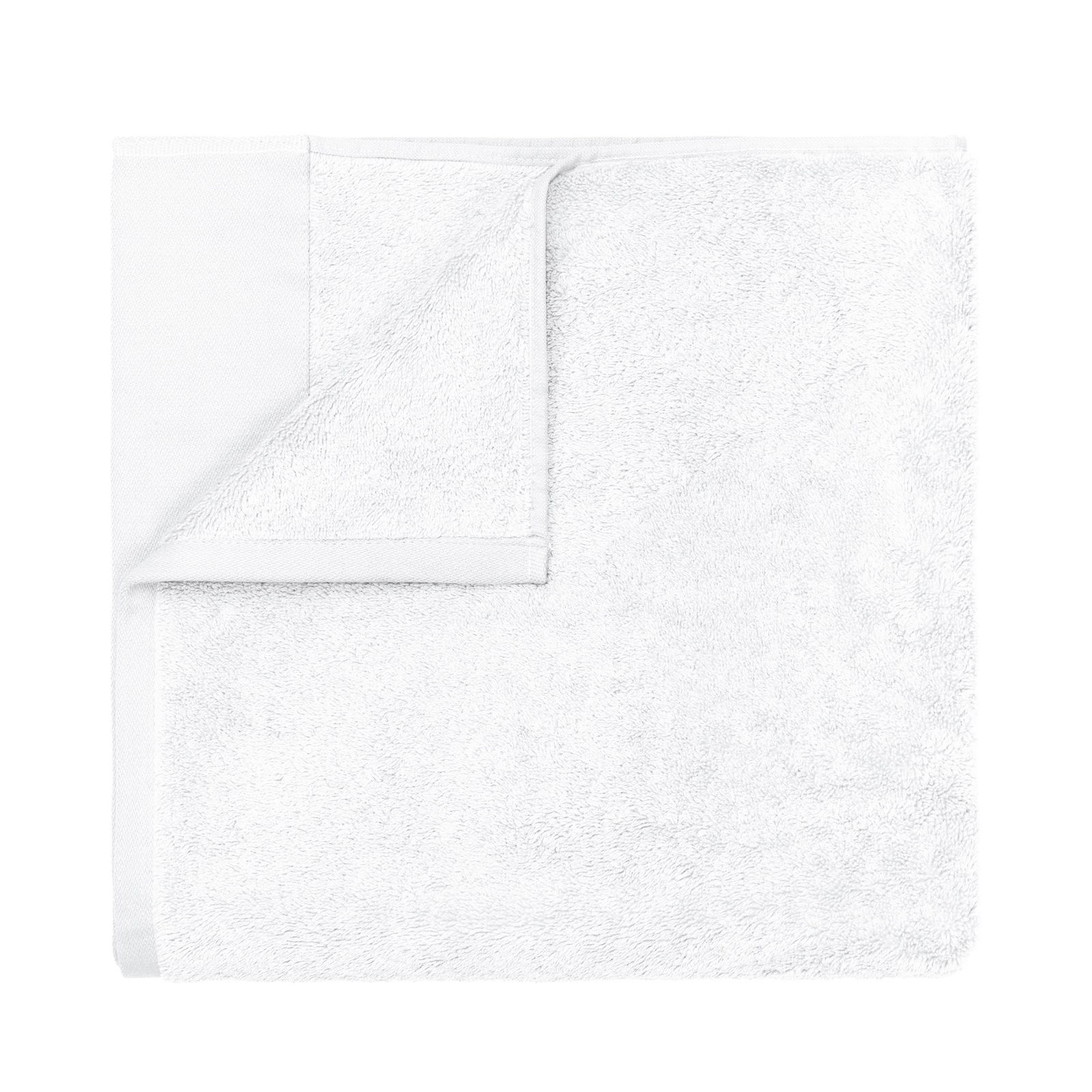 Soft white towel folded neatly on a black background.