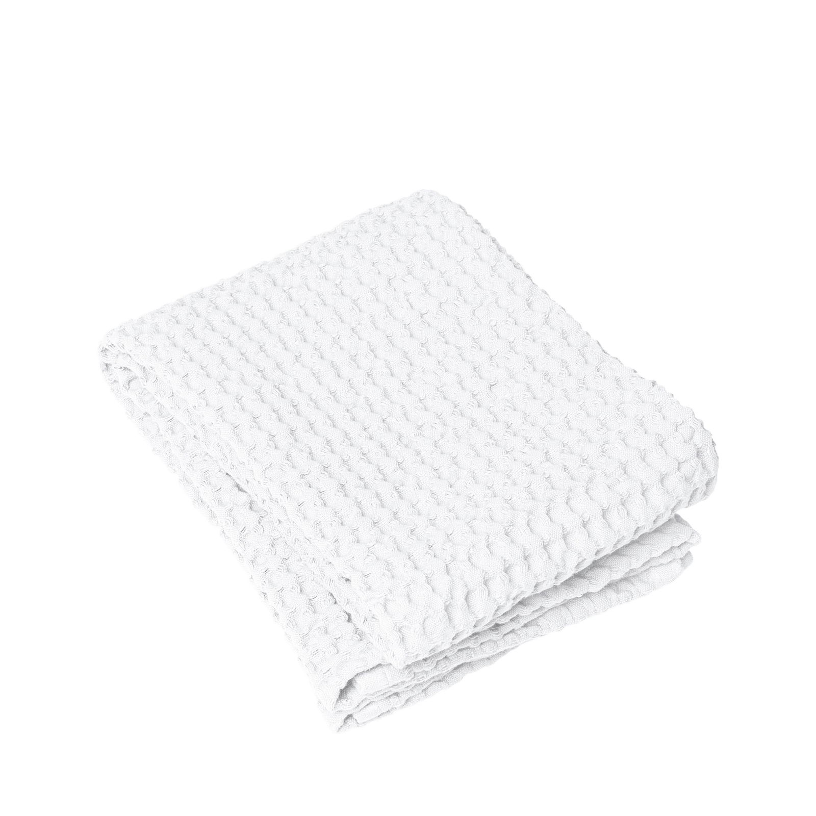 Folded white textured towel on a black background, perfect for home or spa use.