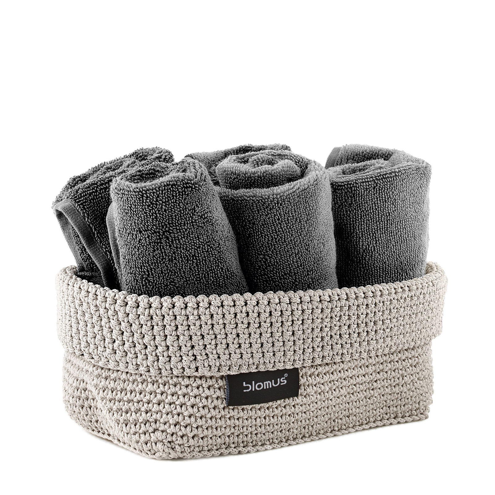 Gray rolled towels in a woven basket, perfect for stylish bathroom organization.