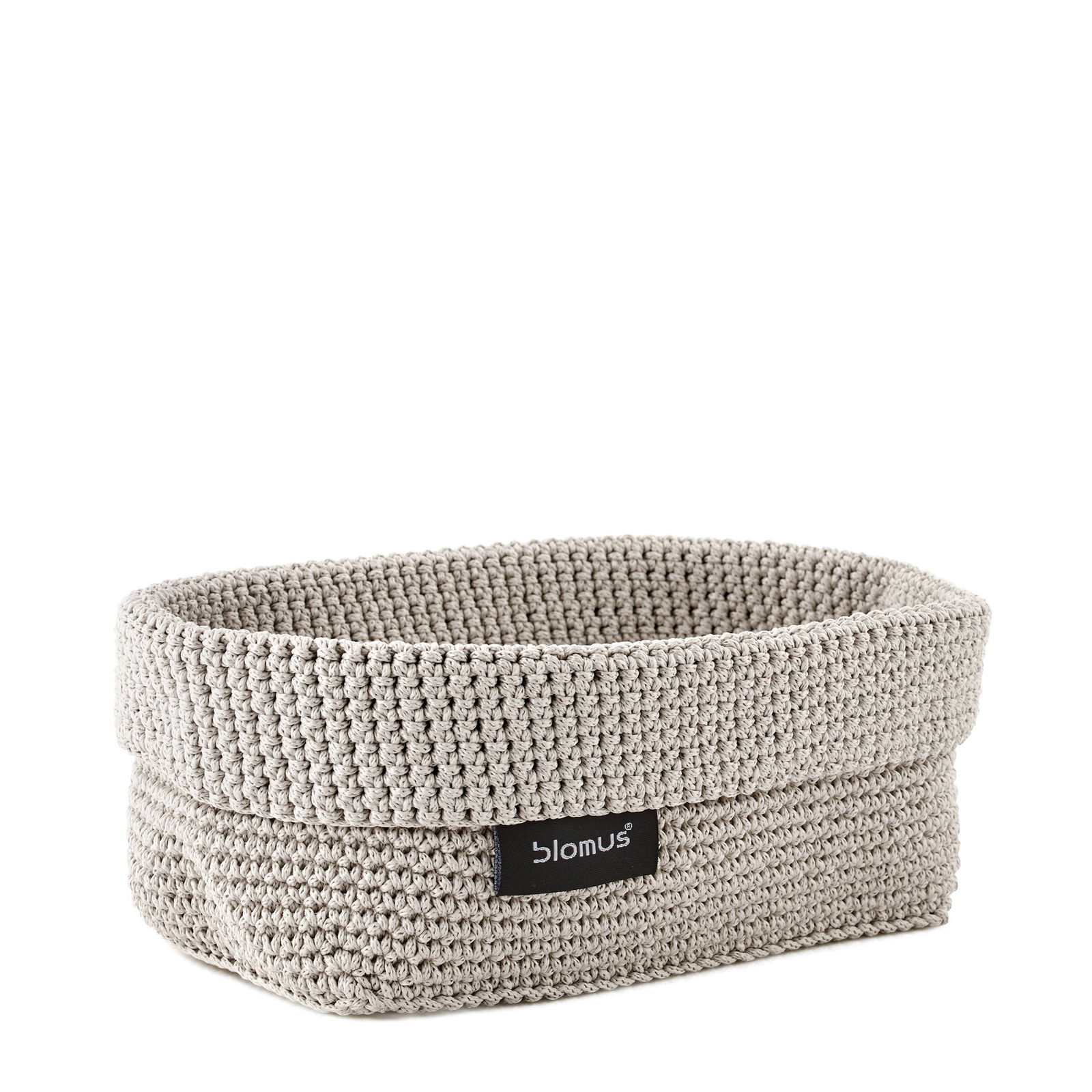 Stylish woven storage basket by Blomus in neutral color for organizing home spaces.