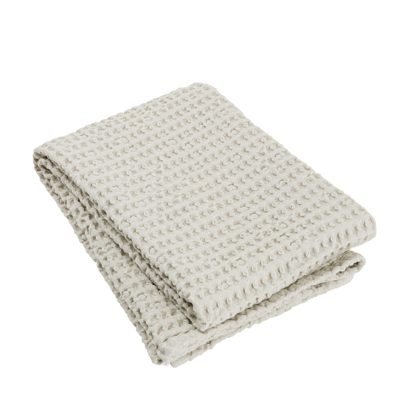 Soft cream-colored cotton blanket folded neatly, perfect for cozy home decor.