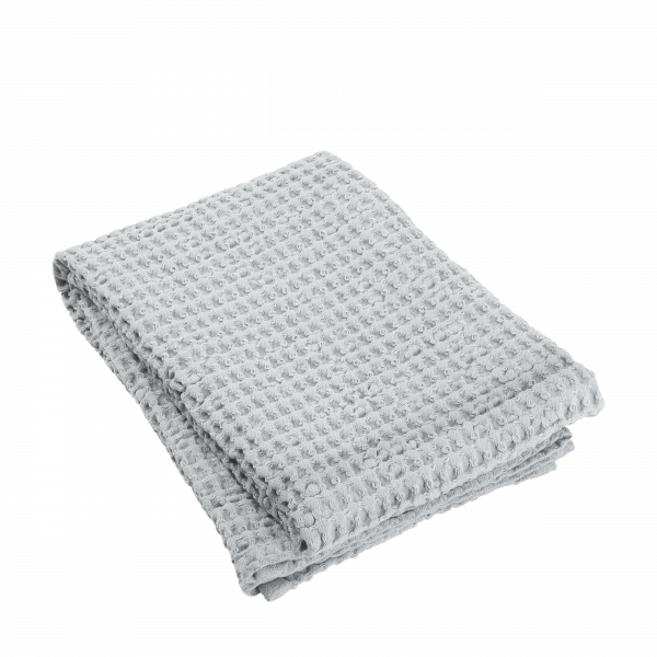 Folded gray waffle blanket on a black background.