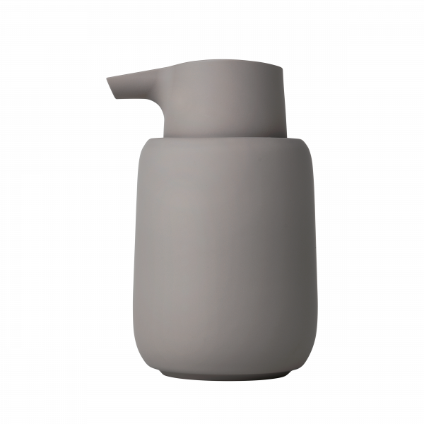Minimalist grauer Keramik-Seifenspender auf schwarzem Hintergrund.