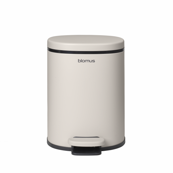 Sleek beige Blomus trash can with a foot pedal for hands-free operation.