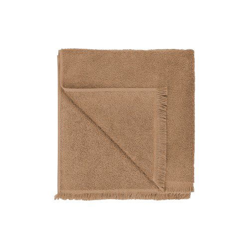 Brown square fabric napkin folded neatly for dining table settings.
