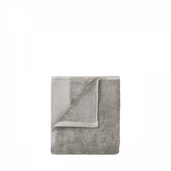 Soft gray towel folded neatly, perfect for bathroom or spa use.