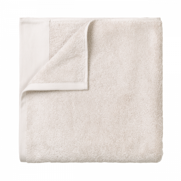 Soft beige towel folded neatly for home or spa use.