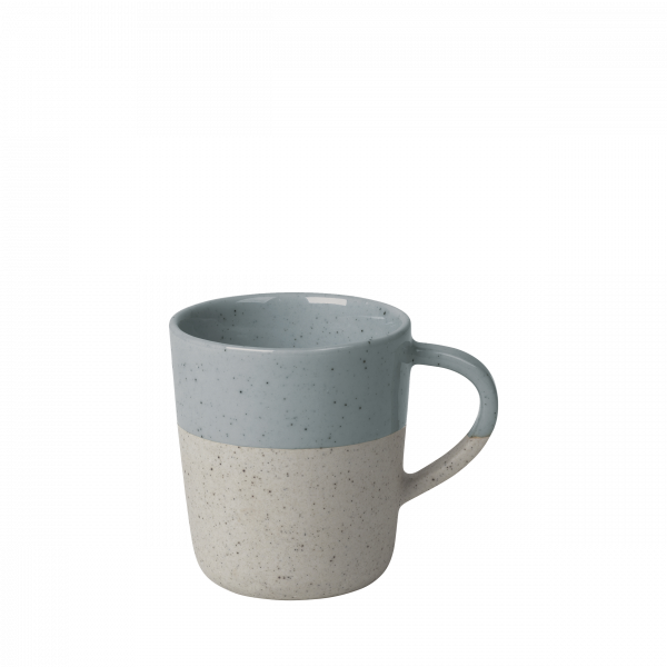 Ceramic mug with a speckled design in light blue and off-white colors.