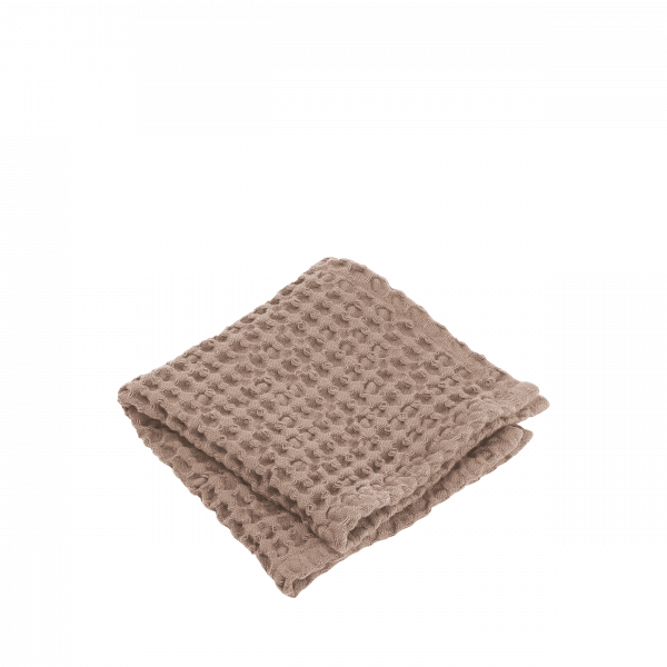 Gemütliche, strukturierte beige Decke ordentlich gefaltet für Wohnkultur und Komfort.
