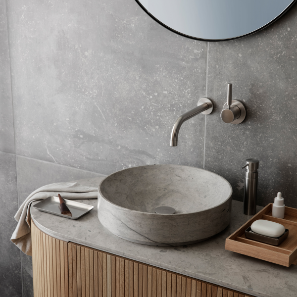 Modern bathroom design featuring a marble sink and sleek fixtures on a wood vanity.
