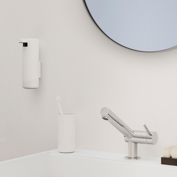 Modern bathroom setting with sleek faucet, mirror, and minimalist toiletries holder.