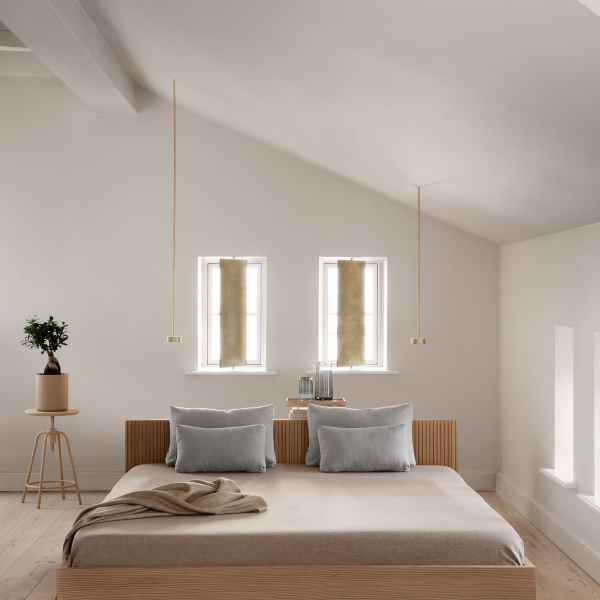 Modern minimalist bedroom with a wooden bed, soft decor, and natural light.