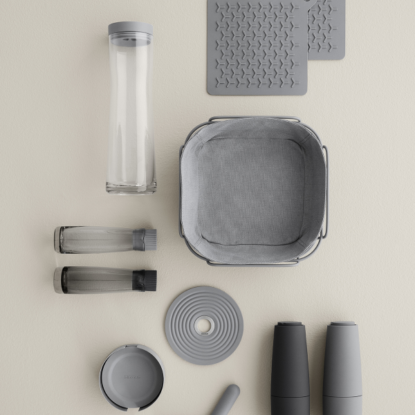 Modern kitchen organization tools including containers and mats on a neutral background.