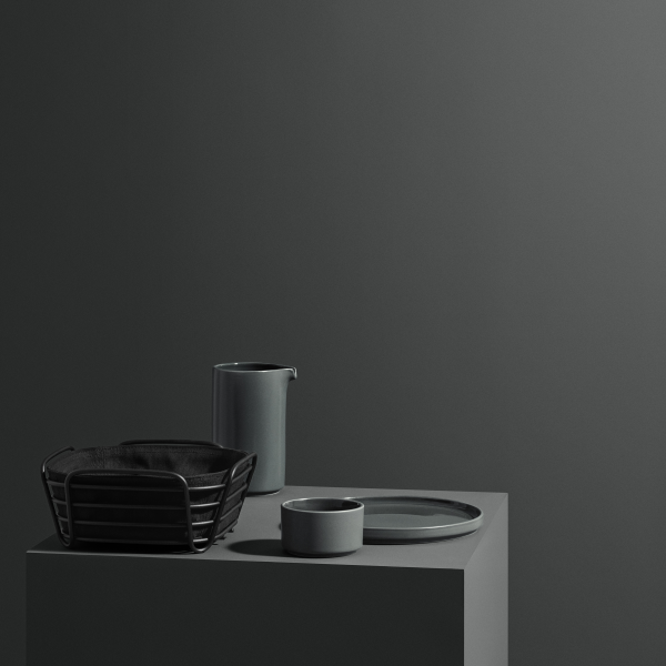 Stylish modern kitchenware in muted tones on a minimalist display.