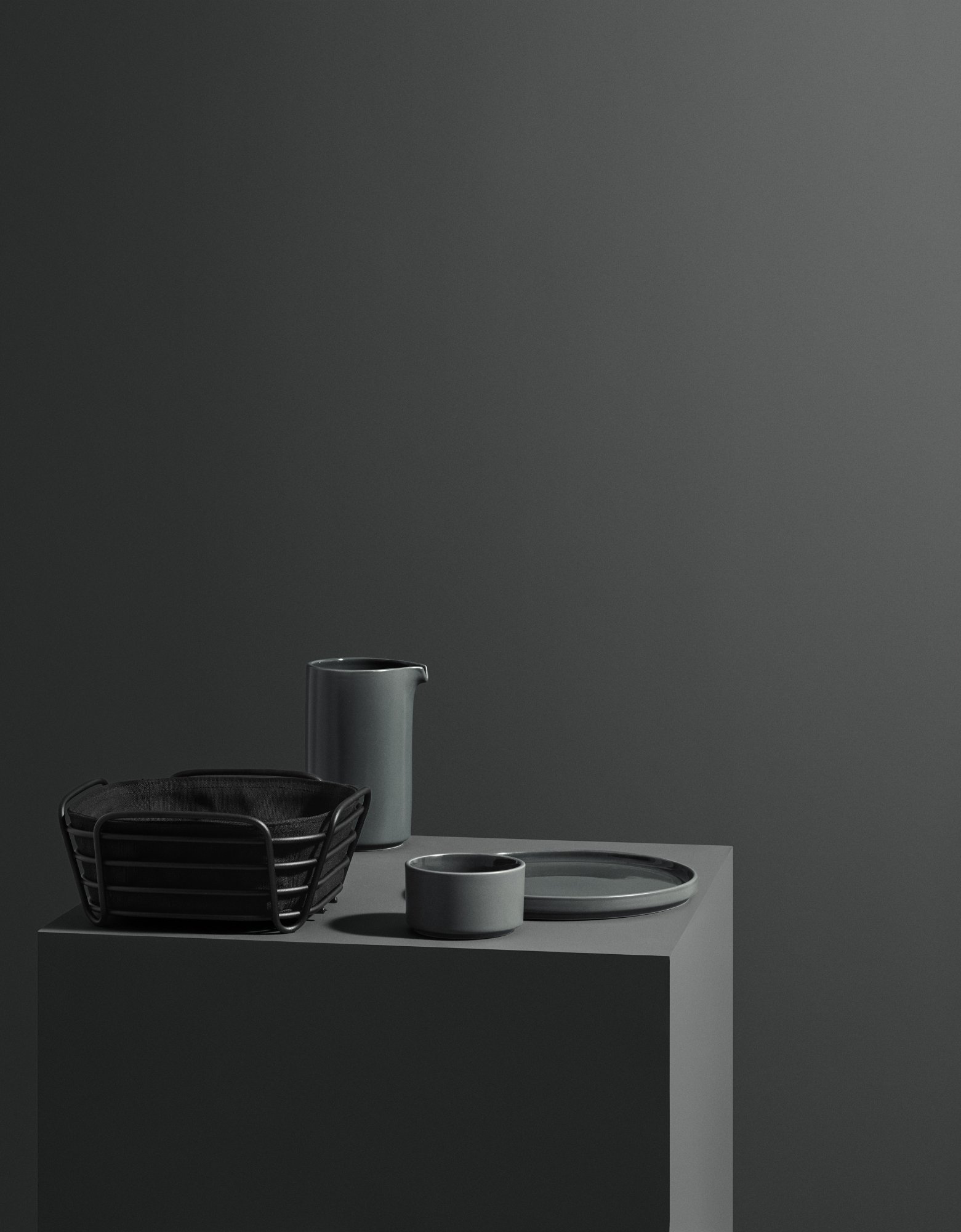 Stylish modern kitchenware in muted tones on a minimalist display.