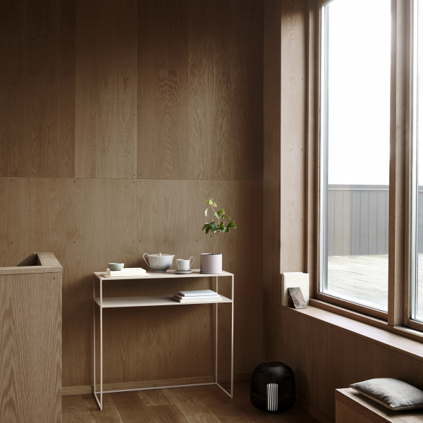 Modern interior design featuring a minimalistic console table and natural wood elements.