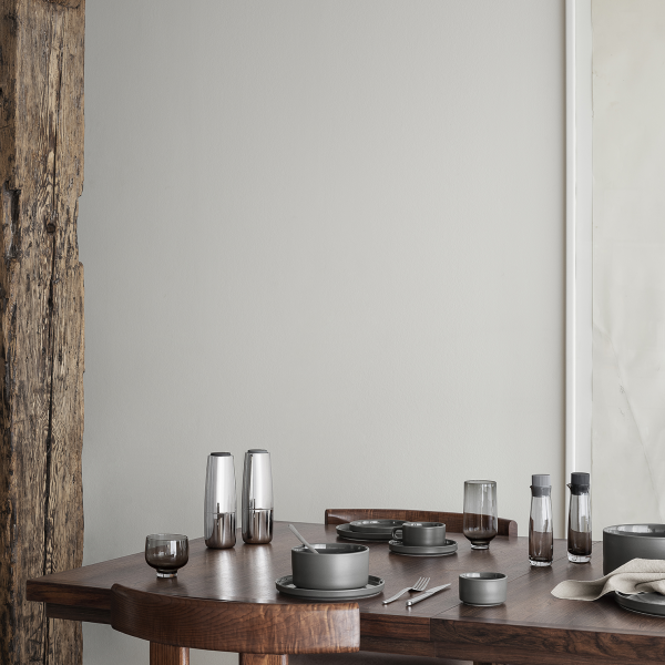 Elegant dining table setup with modern gray dishware and stylish glassware.