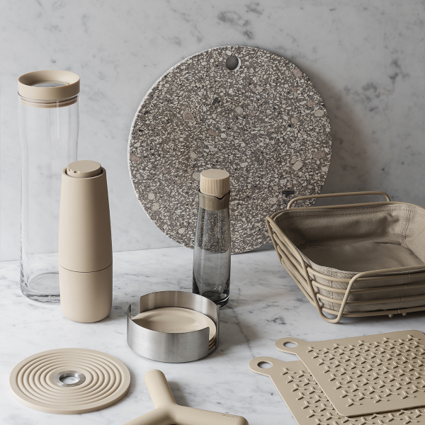 Neutral kitchen accessories arranged on a marble surface for modern home decor inspiration.