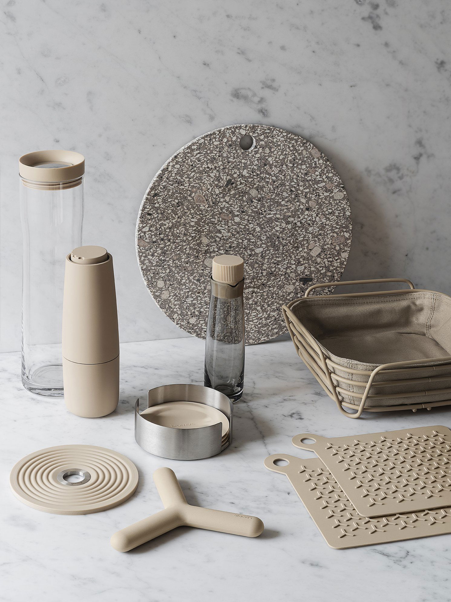 Neutral kitchen accessories arranged on a marble surface for modern home decor inspiration.