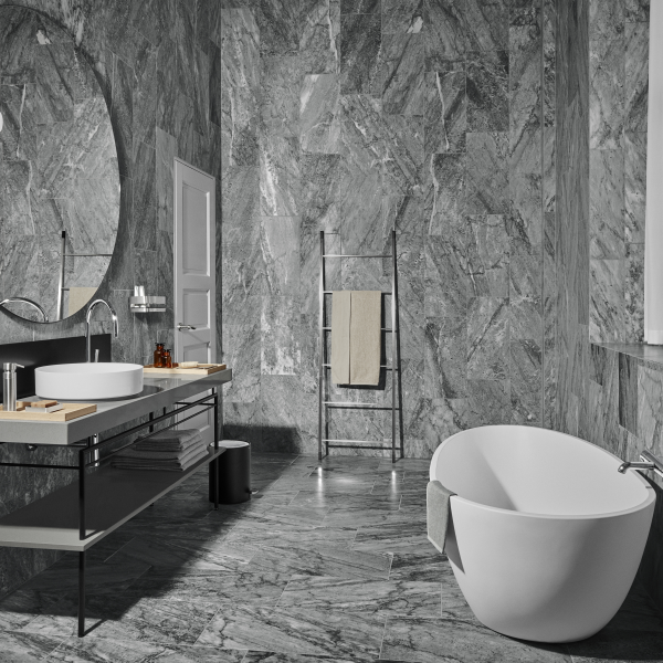 Luxurious gray marble bathroom featuring a modern freestanding bathtub and sleek fixtures.