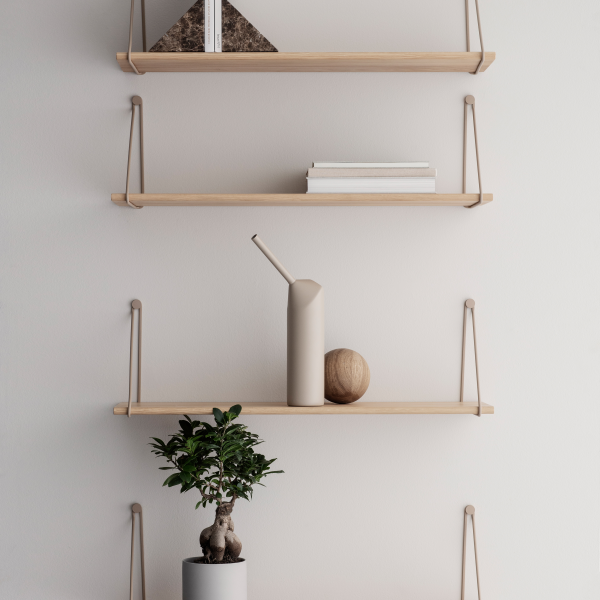 Minimalist wall shelves with decor, plants, and modern vases for stylish interior design.