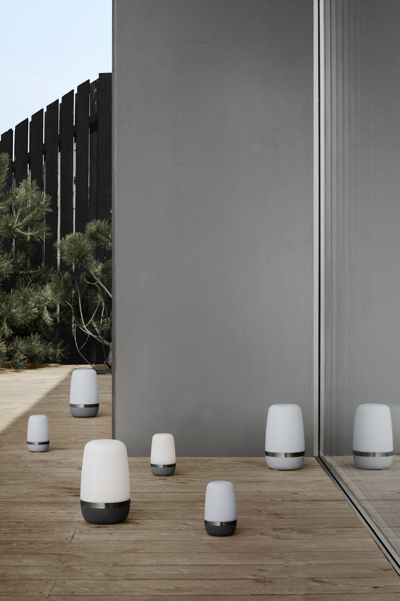 Modern outdoor space featuring stylish luminaire designs on a wooden deck.