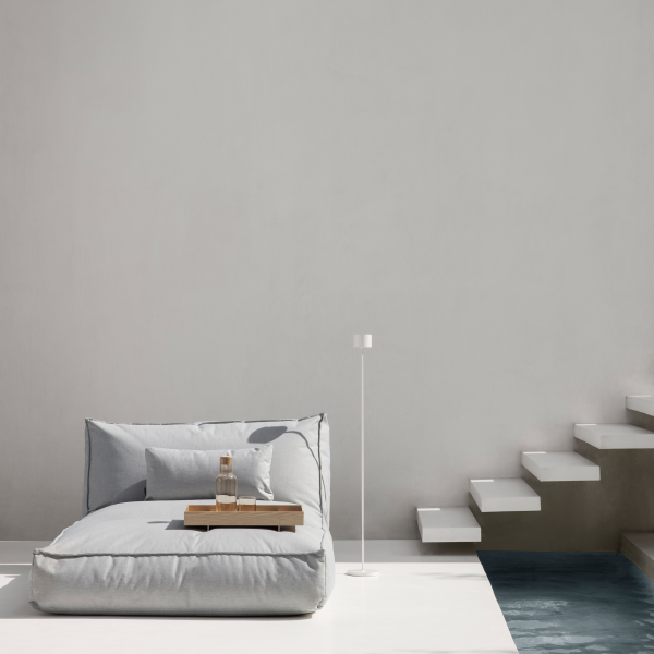 Modern minimalist lounge area featuring a gray bean bag and stylish decor.