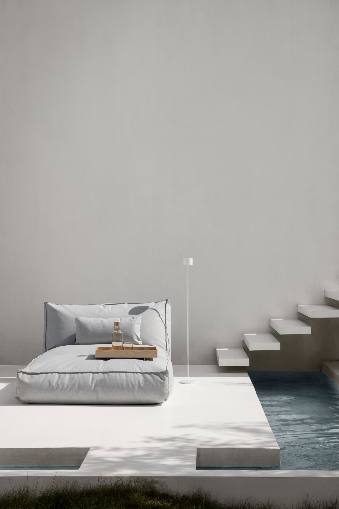 Modern minimalist lounge area featuring a gray bean bag and stylish decor.