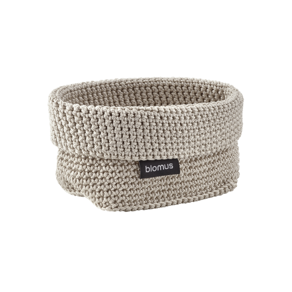 "Soft beige woven storage basket by Blomus, perfect for organizing any space."