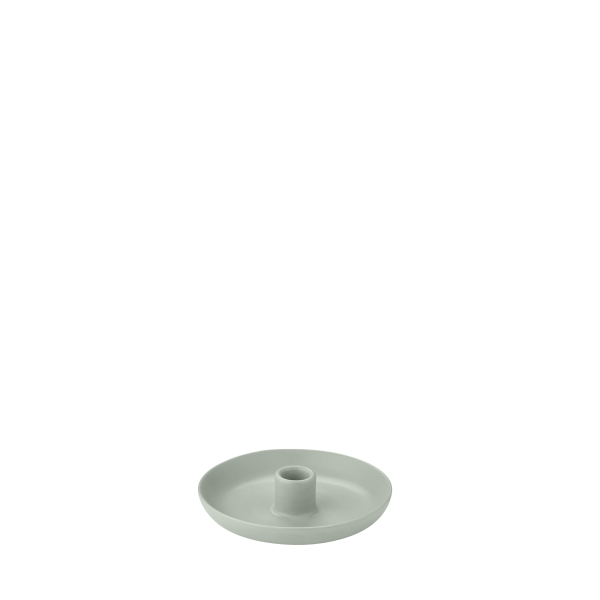 Minimalist grüner keramischer Kerzenhalter auf einem schlichten Hintergrund.