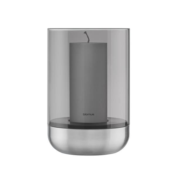 Modern glass candle holder with a gray candle and stainless steel base.