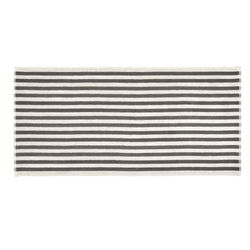 Striped area rug with alternating black and white lines for home decor enhancement.