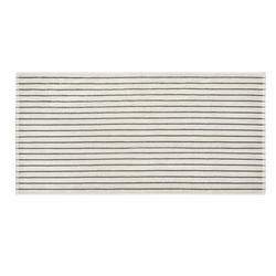 Striped beige bath mat with minimalistic black lines for modern home decor.