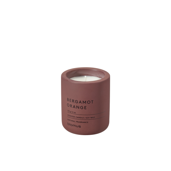 Scented bergamot orange candle in a stylish maroon container on a white backdrop.