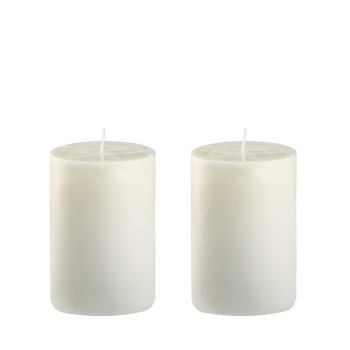 Two elegant white pillar candles on a minimalist background.