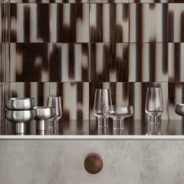 Stylish glassware and metallic bowls on a contemporary kitchen countertop.