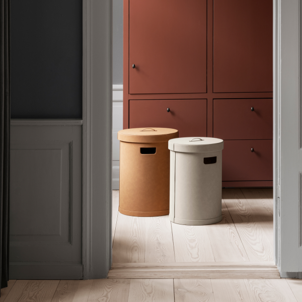 Stilvolle runde Aufbewahrungsboxen in Beige und Creme neben einem modernen Schrank in einem modernen Raum.