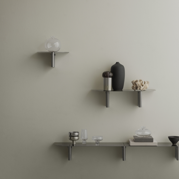 Stylish modern wall shelves showcasing decorative vases and unique decor items.