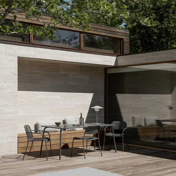 Modern outdoor patio with sleek furniture and minimalist design in a serene setting.