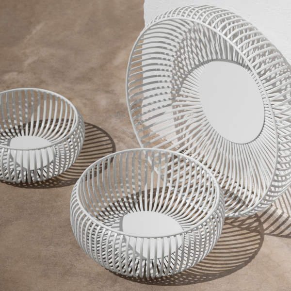Modern white wire baskets set on a textured surface for stylish home decor.