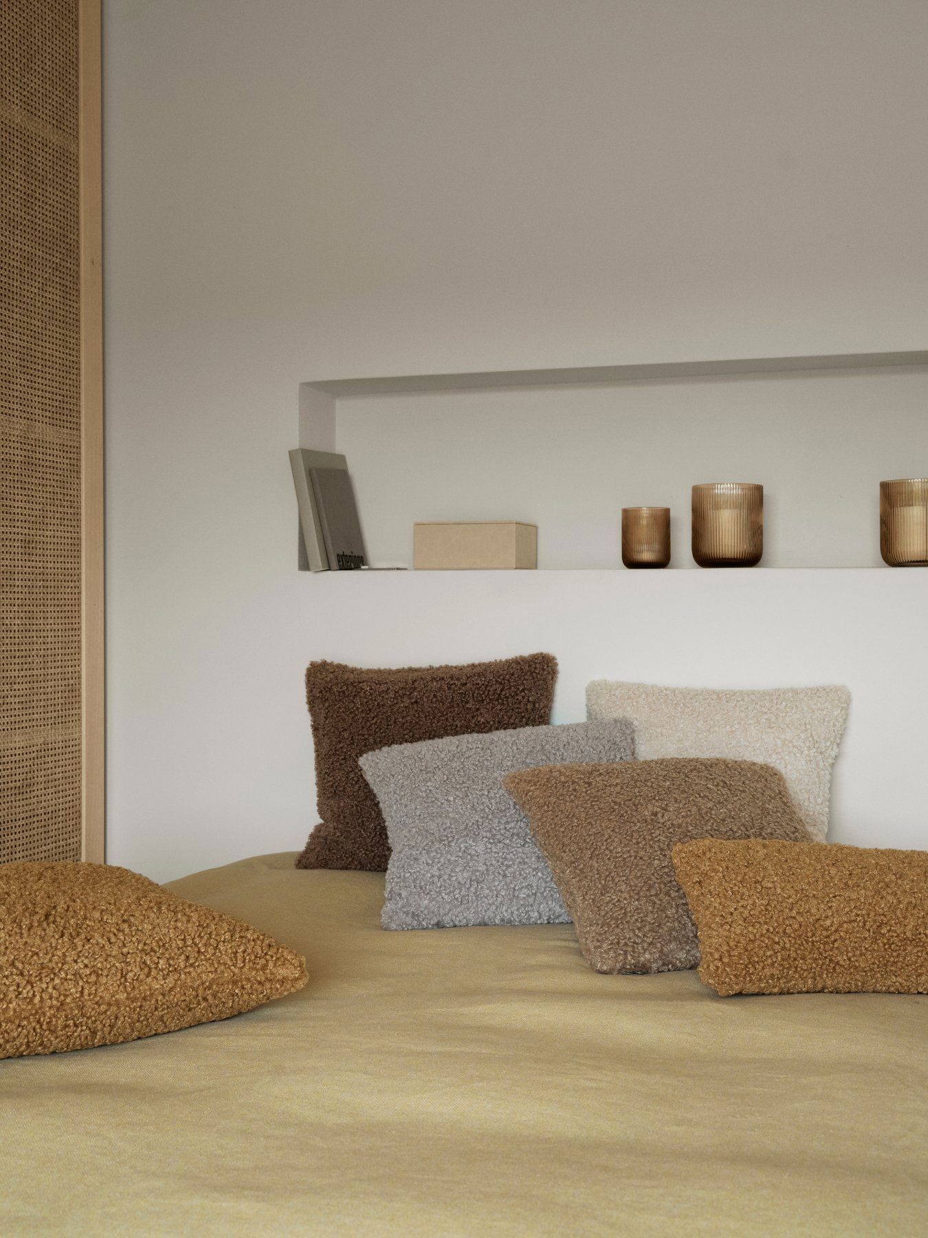 Gemütliches Schlafzimmer mit strukturierten Kissen in warmen Erdtönen und minimalistischem Dekor.
