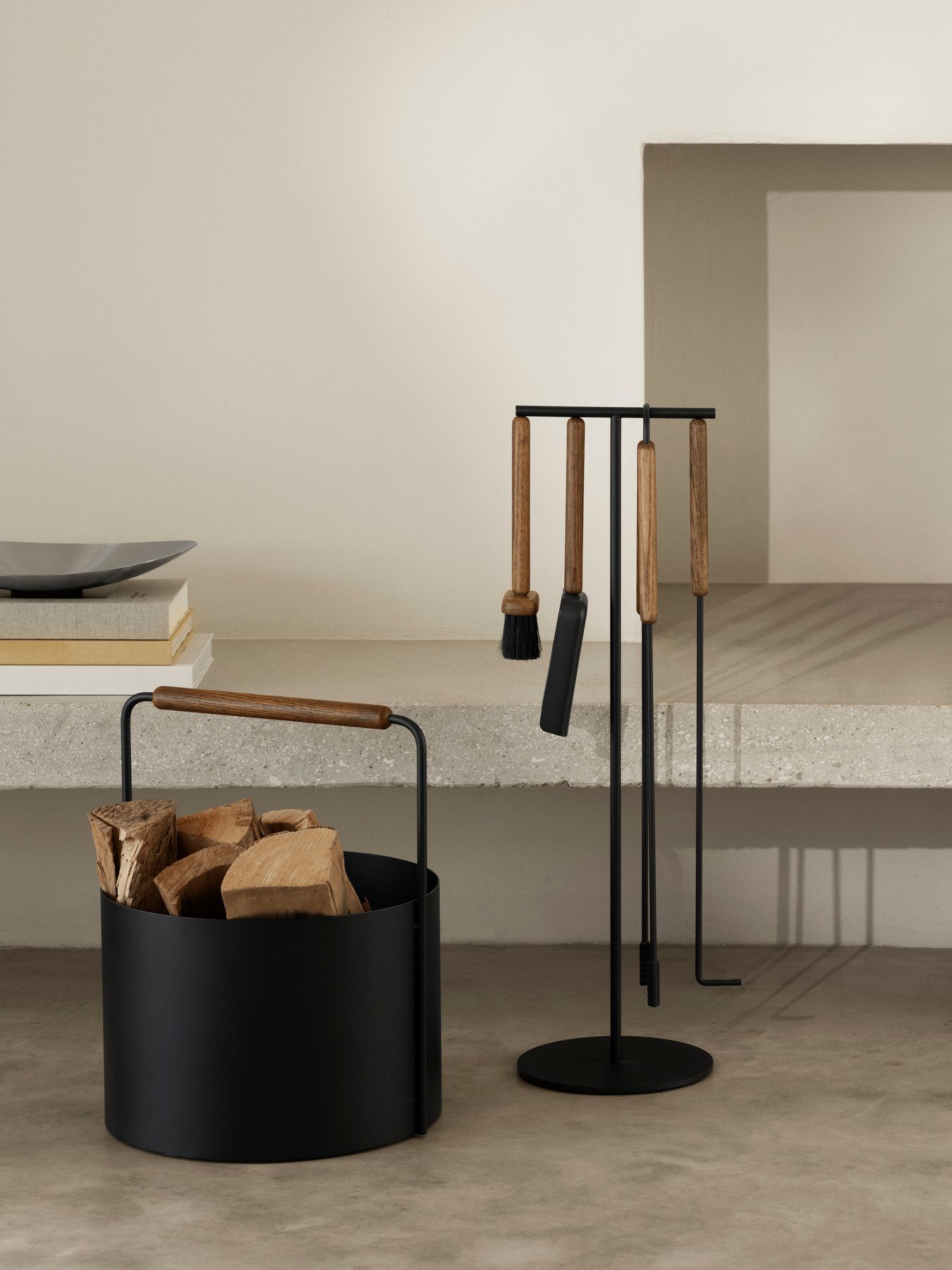 Stylish black metal fireplace tool set with wooden handles and a wood storage container.