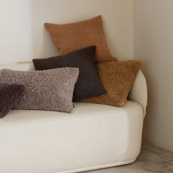 Cozy sofa with decorative throw pillows in earthy tones for a stylish interior.