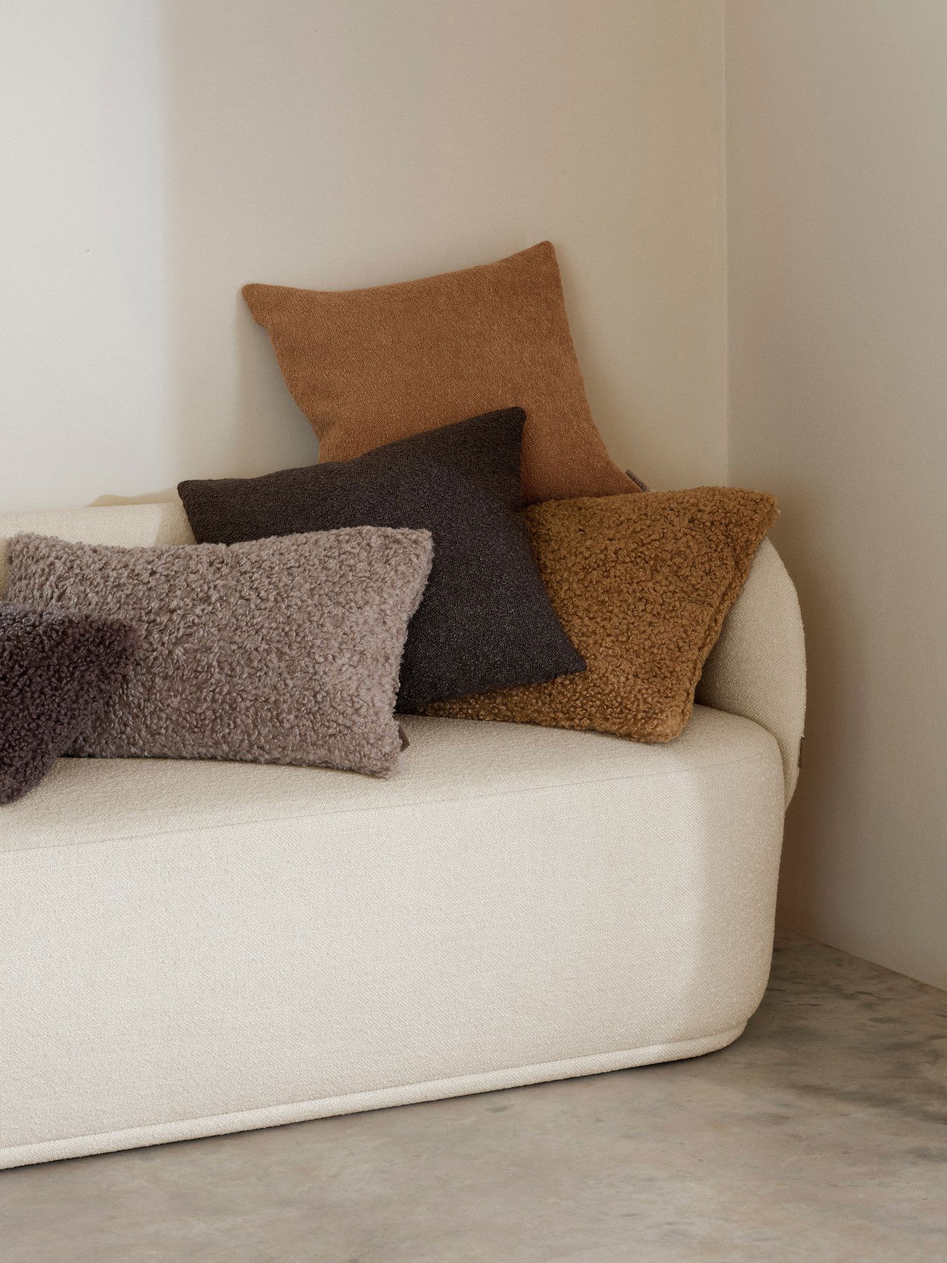 Cozy sofa with decorative throw pillows in earthy tones for a stylish interior.