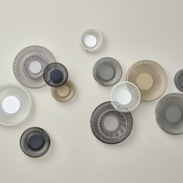Stylish decorative wall plates in various colors and sizes, enhancing modern interior decor.
