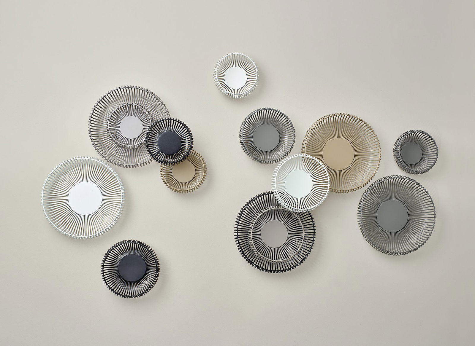 Stylish decorative wall plates in various colors and sizes, enhancing modern interior decor.