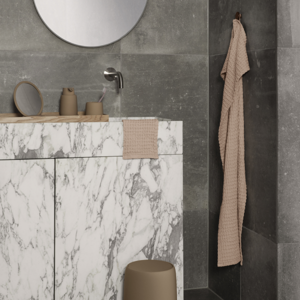 Elegant modern bathroom featuring marble countertops and neutral accessories.
